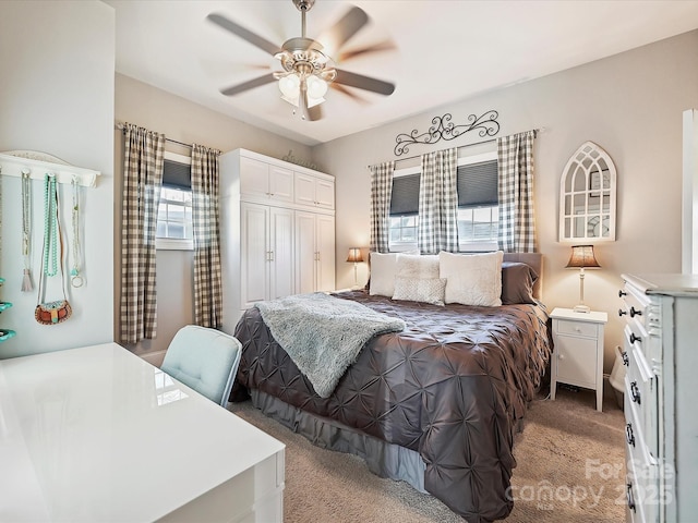 bedroom featuring light carpet, ceiling fan, and a closet