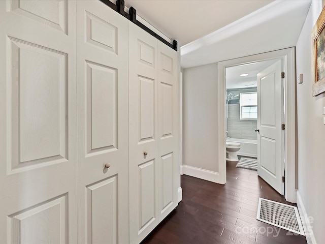 hall with dark hardwood / wood-style floors