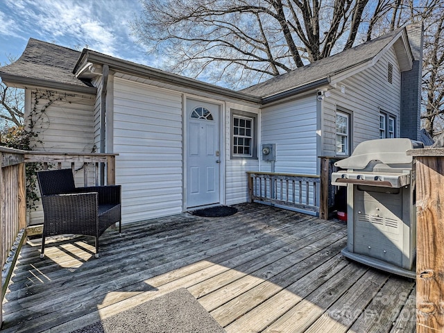 wooden deck with a grill