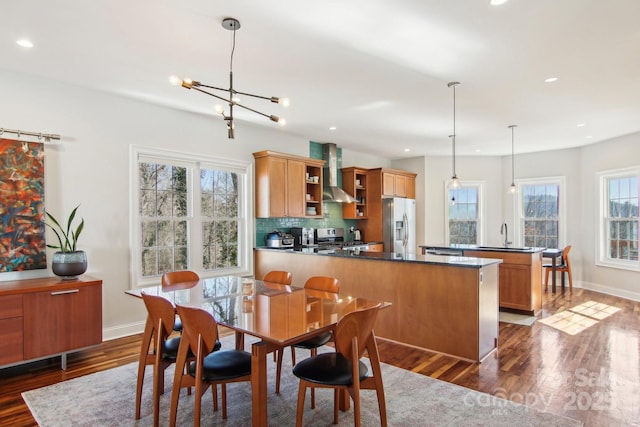 dining room with sink, dark hardwood / wood-style floors, and a chandelier