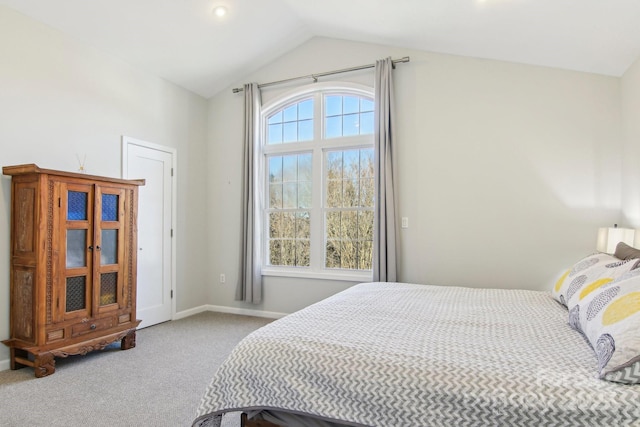 carpeted bedroom with lofted ceiling