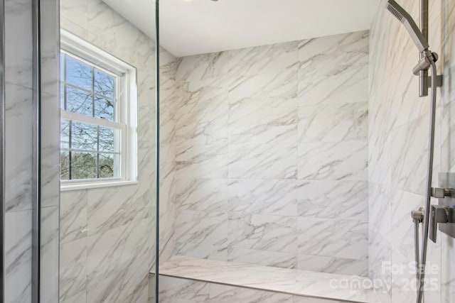 bathroom with tiled shower