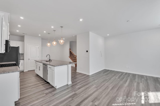 kitchen with white cabinetry, dishwasher, a kitchen island with sink, and pendant lighting