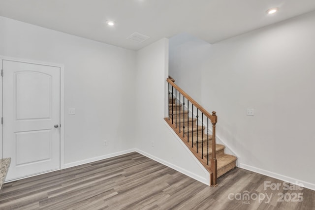 stairway featuring hardwood / wood-style floors