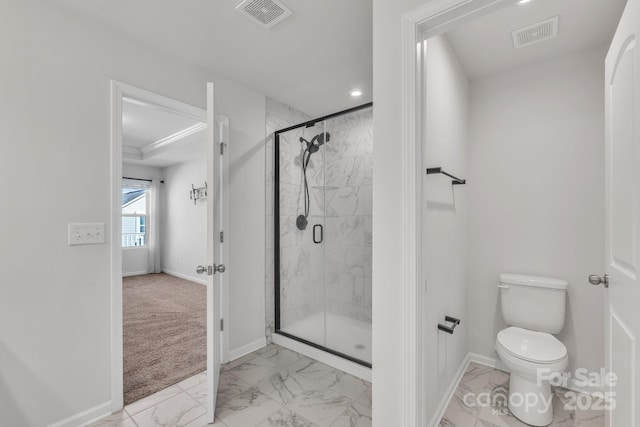 bathroom featuring toilet and a shower with door