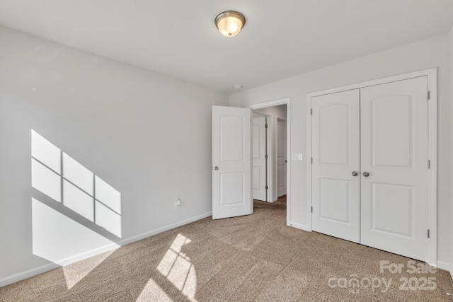 unfurnished bedroom with carpet flooring and a closet