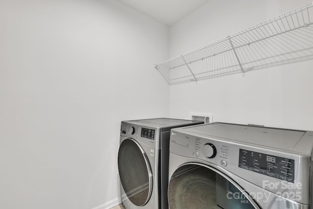 clothes washing area with independent washer and dryer