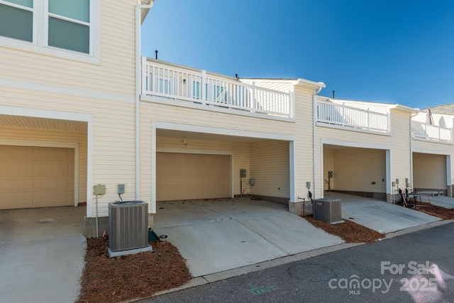 exterior space featuring a garage, central AC, and a balcony