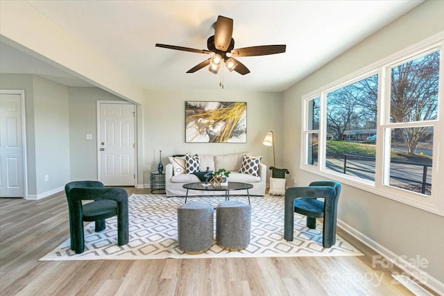 living room featuring ceiling fan and light wood-type flooring