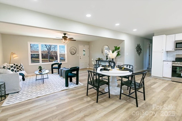 dining space with light hardwood / wood-style floors and ceiling fan