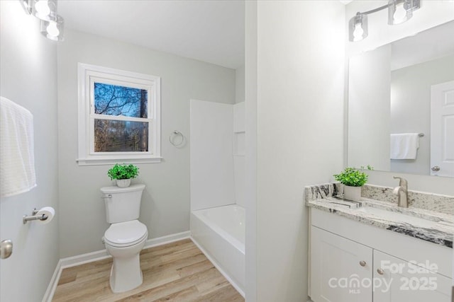 full bathroom with vanity, hardwood / wood-style floors, bathtub / shower combination, and toilet