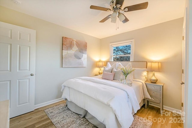 bedroom featuring light hardwood / wood-style floors and ceiling fan