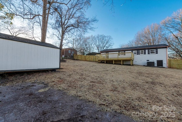 view of yard featuring central AC and a wooden deck