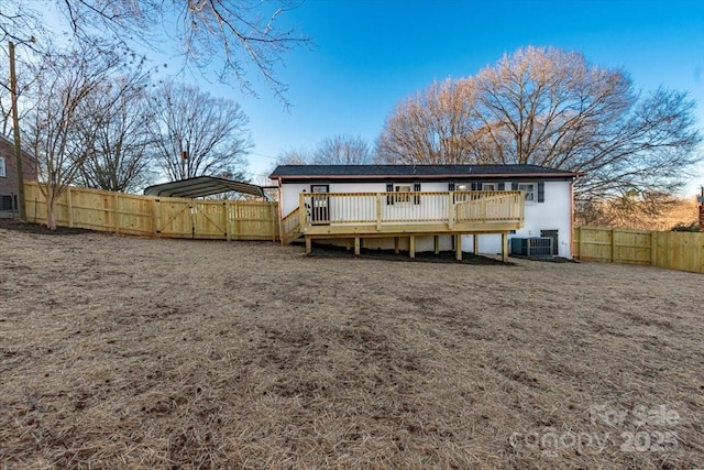 back of property featuring a wooden deck and central AC