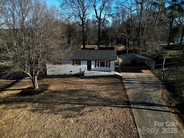 view of front of house with a carport and a front lawn