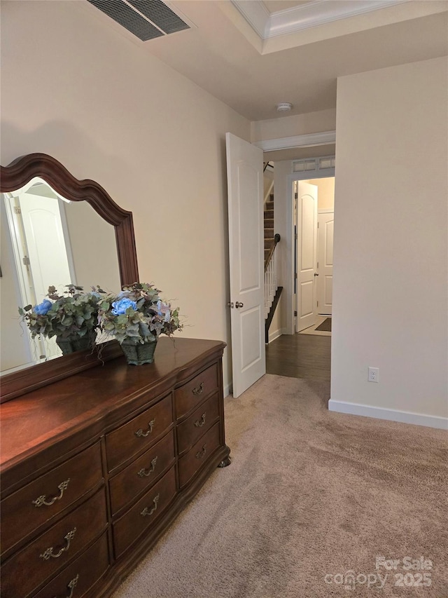 bedroom featuring baseboards, visible vents, and light colored carpet