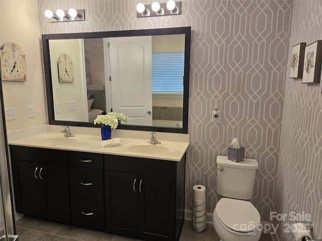 full bath with tile patterned flooring, a sink, toilet, and double vanity