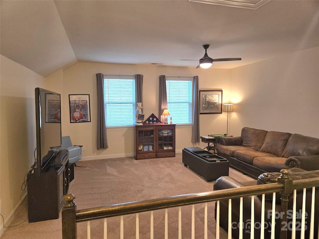 living area featuring carpet floors, lofted ceiling, ceiling fan, and baseboards