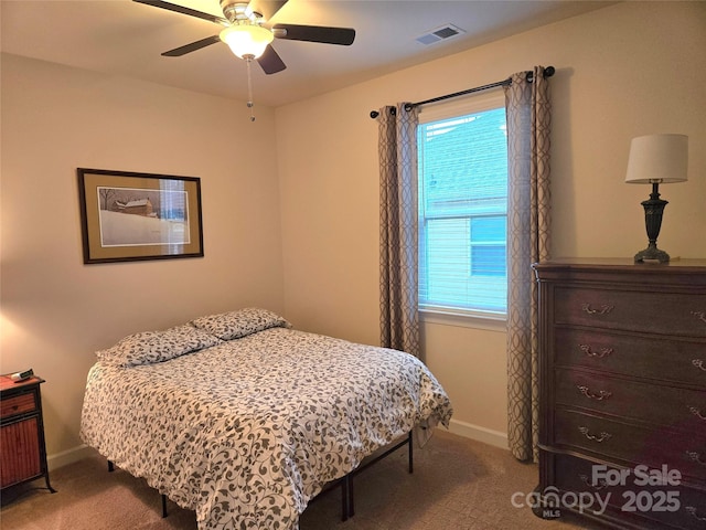 bedroom with baseboards, visible vents, and light colored carpet