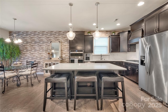 4929 Norman Park Pl, Clover, SC 29710 - kitchen featuring a kitchen breakfast bar, a sink, stainless steel appliances, light countertops, and dark brown cabinetry