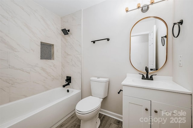 full bathroom with hardwood / wood-style flooring, vanity, tiled shower / bath combo, and toilet