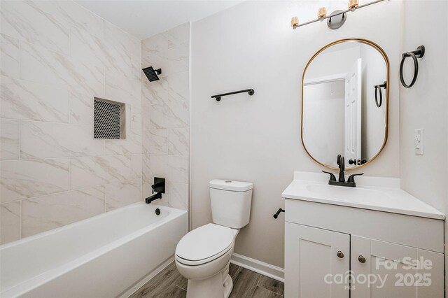 full bathroom with toilet, wood finished floors, vanity, bathing tub / shower combination, and baseboards