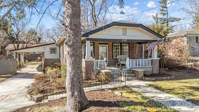 view of front of property featuring a carport and a porch