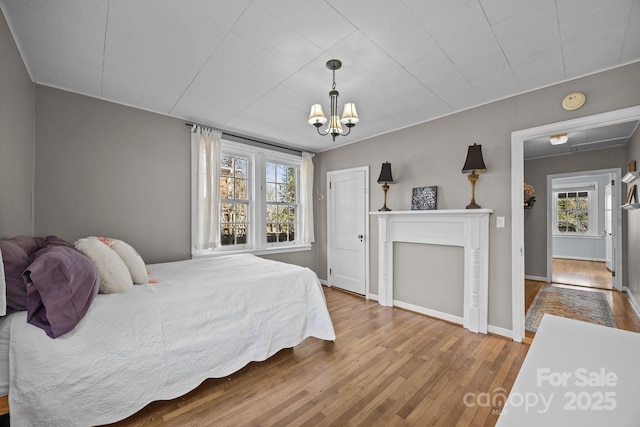 bedroom with an inviting chandelier and wood-type flooring