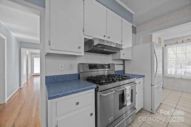 kitchen featuring crown molding, double oven range, white fridge, white cabinets, and light wood-type flooring