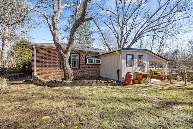 rear view of property featuring a yard