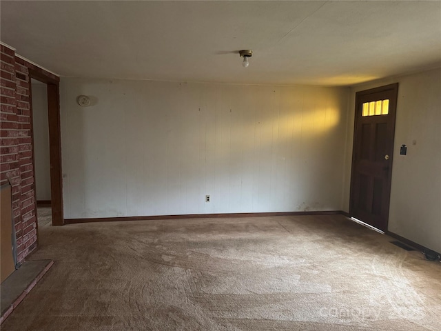 empty room featuring a fireplace and carpet floors