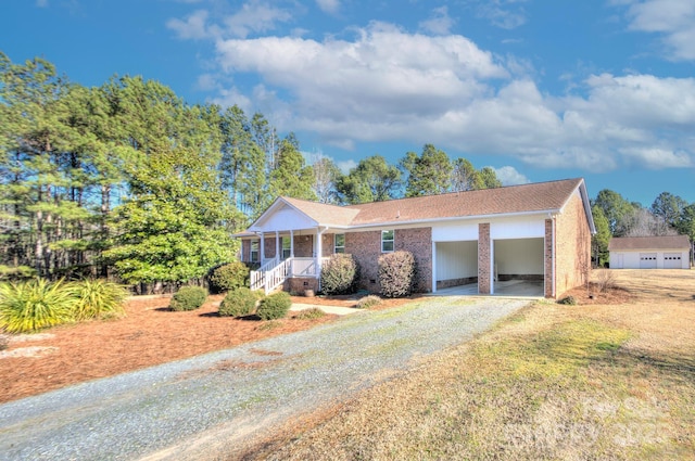 view of front facade with a front yard, a carport, and covered porch