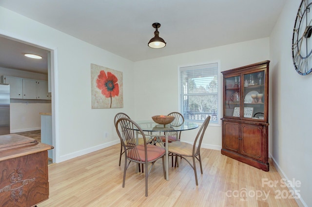 dining space with light wood-type flooring