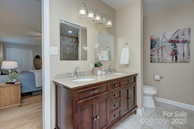 bathroom with vanity, toilet, and tile patterned flooring