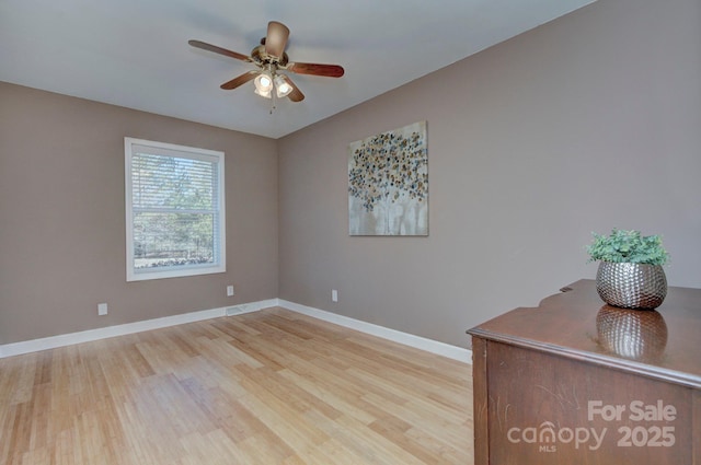 empty room featuring ceiling fan and light wood-type flooring