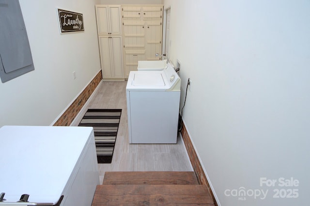 laundry area featuring sink, independent washer and dryer, and light wood-type flooring