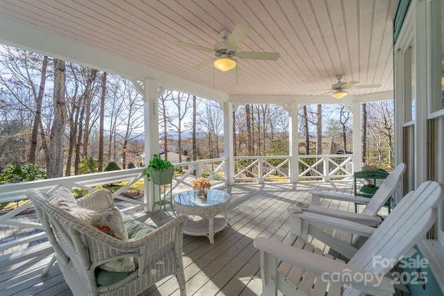 wooden deck featuring ceiling fan