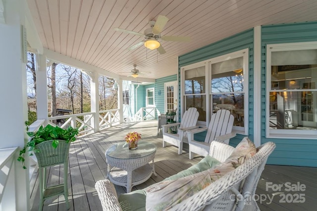 sunroom / solarium with wood ceiling and ceiling fan