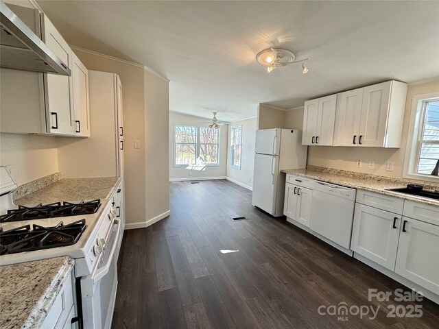 436 Riverwind Dr, Hendersonville, NC 28739 - kitchen with dark hardwood / wood-style floors, white cabinetry, light stone countertops, wall chimney range hood, and white appliances