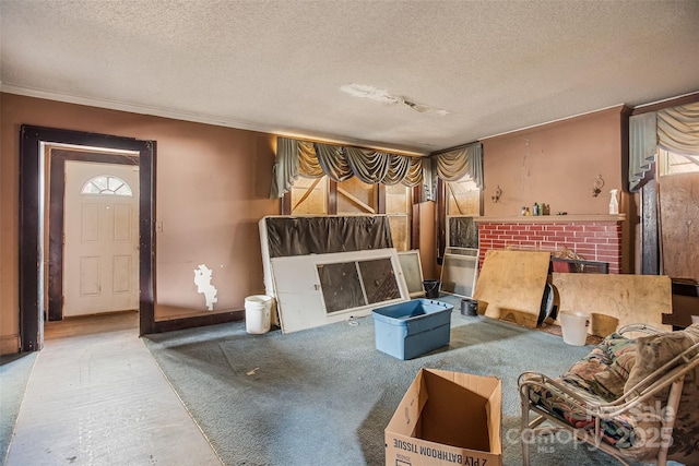 sitting room with crown molding and a textured ceiling