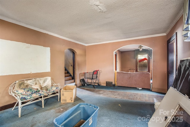 living area featuring ornamental molding, carpet flooring, and a textured ceiling