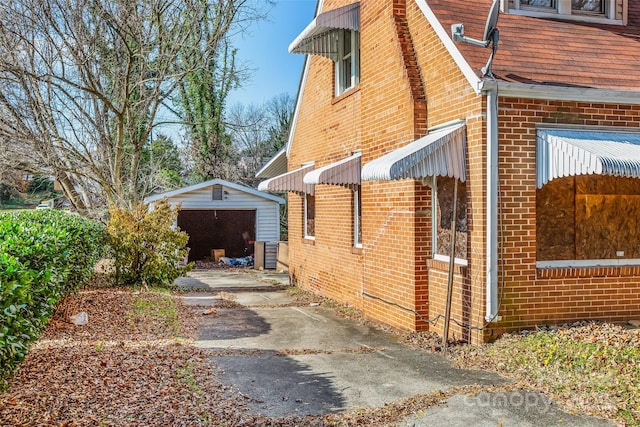 view of home's exterior with a garage and an outdoor structure