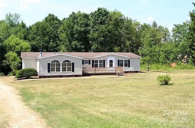 back of house featuring a yard and a deck