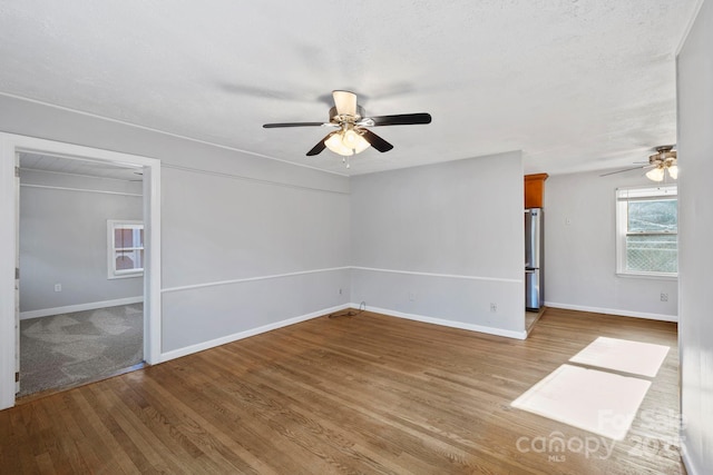 16 Rosscraggon Dr, Asheville, NC 28803 - unfurnished room with a textured ceiling, light hardwood / wood-style floors, and ceiling fan