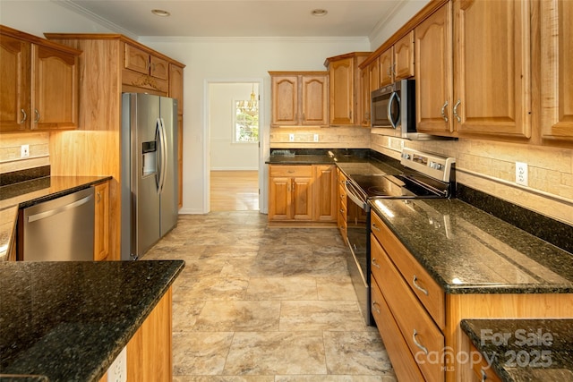 kitchen featuring stainless steel appliances, tasteful backsplash, and dark stone counters