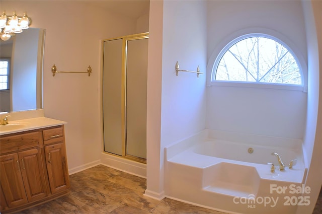 bathroom featuring vanity and independent shower and bath