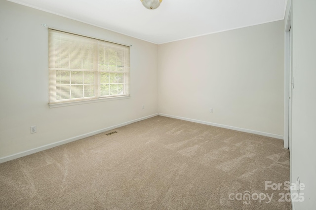 spare room with light colored carpet