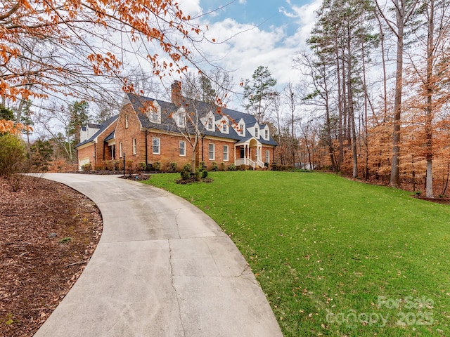 cape cod-style house featuring a front yard