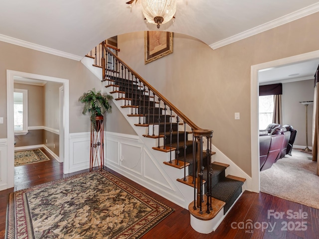 stairs with crown molding and hardwood / wood-style flooring