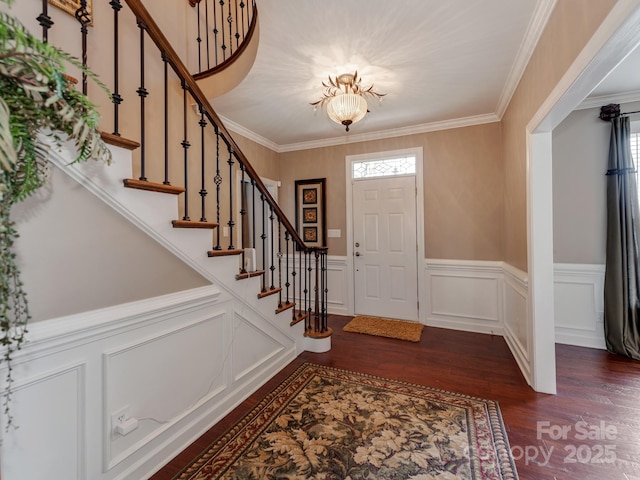 foyer with crown molding, plenty of natural light, and dark hardwood / wood-style floors